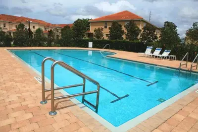 a large swimming pool with blue water at Cozy Home with 3BD & BBQ Grill in Orlando