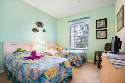 a bedroom with two beds with stuffed animals on them at Windsor Palms Condo | Pool, Spa & Near Disney in Kissimmee