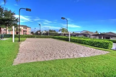 a sand path in a park with houses and street lights at Windsor Palms Condo | Pool, Spa & Near Disney in Kissimmee