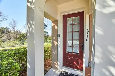 a red door on the side of a house at Windsor Palms Escape w/ Splash Pool in Kissimmee