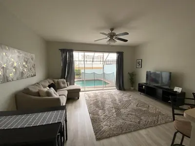 a living room with a couch and a ceiling fan at Townhome in Orlando