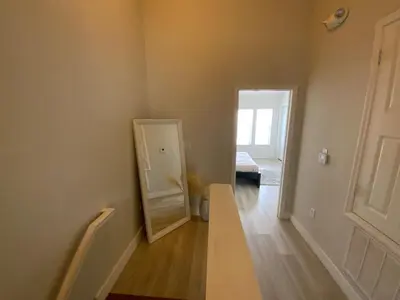 a hallway with a door and a mirror in a room at Townhome in Orlando