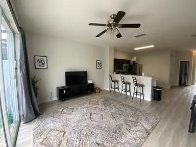 a living room with a ceiling fan and a rug at Townhome in Orlando