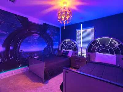 a purple room with two beds and a chandelier at Lovely Themed Room with Private Pool in Kissimmee