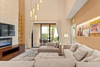 a living room with two couches and a tv at Magic Village 4 suítes 8 min da Disney perto da 192 in Orlando