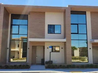 a building with large windows on the side of it at 3053 Magic Village - Jacuzzi excepcional, a 8 minutos da Disney in Orlando