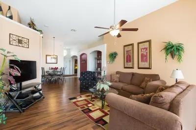 a living room with a couch and a ceiling fan at Windsor Palms Villa: Pool & Close to Disney in Kissimmee