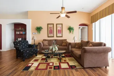 a living room with a couch and a table at Windsor Palms Villa: Pool & Close to Disney in Kissimmee
