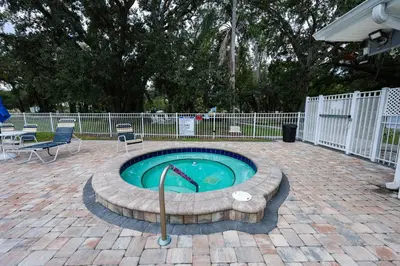 a small swimming pool with a metal rail in a yard at New! Family cottage near Disney-Sleep 6 in Kissimmee