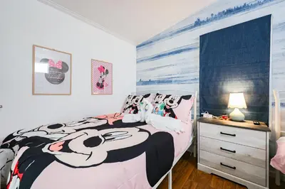 a bedroom with a black and white bed and a dresser at New! Family cottage near Disney-Sleep 6 in Kissimmee