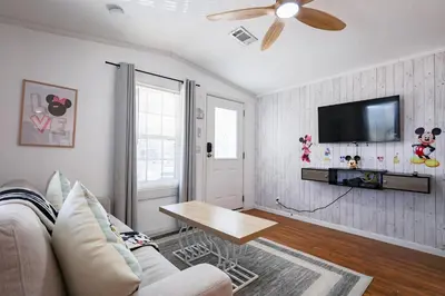 a living room with a couch and a flat screen tv at New! Family cottage near Disney-Sleep 6 in Kissimmee