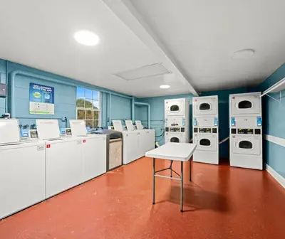 a laundry room with washing machines and a table at Magic Tree Resort by Coolvacay in Orlando