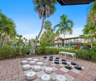 a chess board on a patio with palm trees at Magic Tree Resort by Coolvacay in Orlando