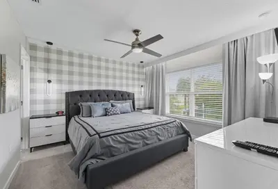 a bedroom with a bed and a ceiling fan at Beautiful 4BD home Themed Pool and Grill 4403 in Kissimmee