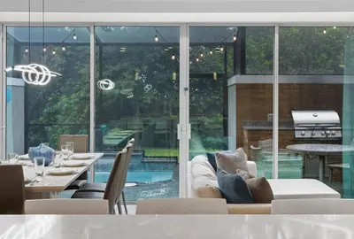 a living room with a couch and a large window at Beautiful 4BD home Themed Pool and Grill 4403 in Kissimmee