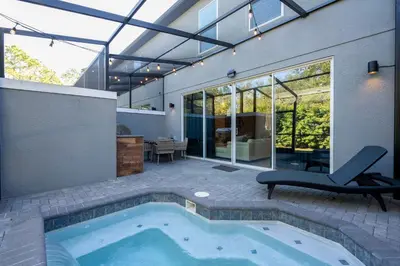 a swimming pool in the middle of a house at Beautiful 4BD home Themed Pool and Grill 4403 in Kissimmee