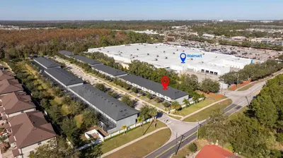an overhead view of a building with a parking lot at Beautiful 4BD home Themed Pool and Grill 4403 in Kissimmee