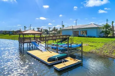 a group of inflatable boats on a dock in the water at Aqua Vista Gated Resort Style Community Storey Lake in Kissimmee