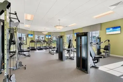 a gym with treadmills and machines in a room at Aqua Vista Gated Resort Style Community Storey Lake in Kissimmee