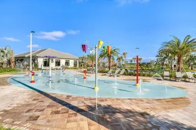 a group of water fountains in a park at Aqua Vista Gated Resort Style Community Storey Lake in Kissimmee