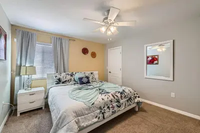 a bedroom with a bed and a ceiling fan at Luxury 5BR Townhome w Pool & Resort Access in Kissimmee