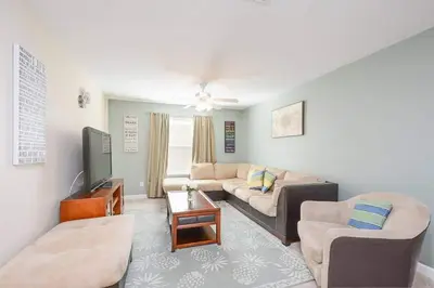 a living room with a couch and a tv at Spacious 6BR Villa Sleeps 14 in Kissimmee