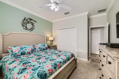 a bedroom with a bed and a ceiling fan at Spacious 6BR Villa w Pool, Game Room & View in Kissimmee