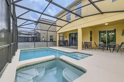 a swimming pool in the backyard of a house at Spacious 6BR Villa w Pool, Game Room & View in Kissimmee