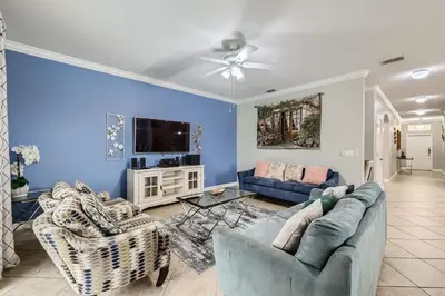 a living room with two couches and a tv at Spacious 6BR Villa w Pool, Game Room & View in Kissimmee