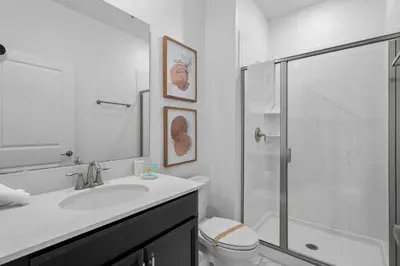 a white bathroom with a sink and a shower at Relaxing Getaway Near Disney with Pool & Themed Rooms in Kissimmee
