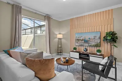 a living room with a couch and a table at Relaxing Getaway Near Disney with Pool & Themed Rooms in Kissimmee