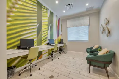 an office with chairs and a desk with a computer at Relaxing Getaway Near Disney with Pool & Themed Rooms in Kissimmee