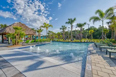 a swimming pool at a resort with palm trees at Relaxing Getaway Near Disney with Pool & Themed Rooms in Kissimmee
