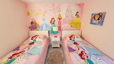 two beds in a room with a disney princess bedroom at Ultimate family resort home with incredible sunset views, 4 miles from Disney! in Kissimmee