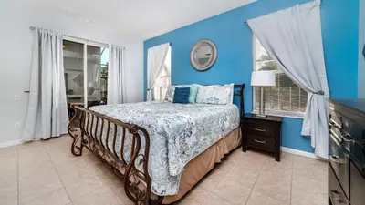 a bedroom with a bed and a blue wall at Windsor Palms Resort Vacation Home 5BR in Kissimmee