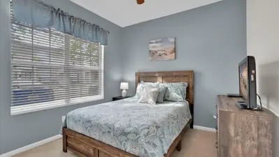 a bedroom with a bed and a television and a window at SPD2326 in Kissimmee