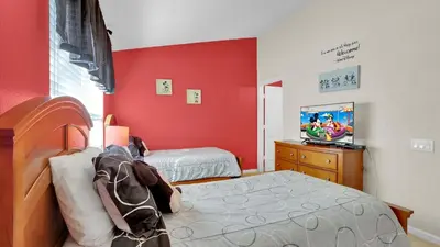 a bedroom with two beds and a television in it at SPD2326 in Kissimmee