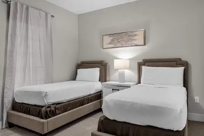 a bedroom with two beds and a lamp in it at 3 Bedroom Family Friendly Condo at WorldQuest near Disney 2714 in Orlando