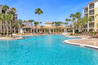 a swimming pool at a resort with palm trees at 3 Bedroom Family Friendly Condo at WorldQuest near Disney 2729 in Orlando