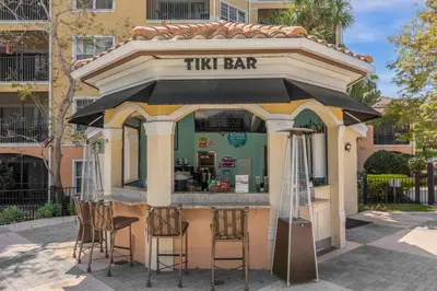 a tiny bar with stools in front of a building at 3 Bedroom Family Friendly Condo at WorldQuest near Disney 2729 in Orlando