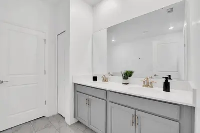 a white bathroom with a sink and a mirror at Serenity Lakeview Retreat Stunning Water Views, No Rear Neighbors, Private Pool, Game Room Star Wars Cinema in Kissimmee