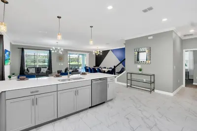 a large living room with a kitchen and a living room at Serenity Lakeview Retreat Stunning Water Views, No Rear Neighbors, Private Pool, Game Room Star Wars Cinema in Kissimmee