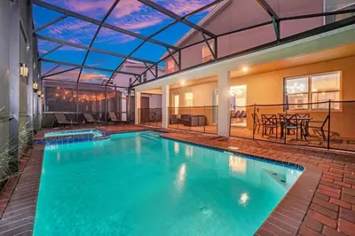 an indoor swimming pool with a glass ceiling at Serenity Lakeview Retreat Stunning Water Views, No Rear Neighbors, Private Pool, Game Room Star Wars Cinema in Kissimmee