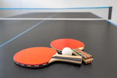 two tennis rackets and a ball on a table at Near Disney with Pool and BBQ 4BD Single House in Kissimmee
