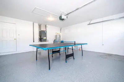 a ping pong table in an empty room at Near Disney with Pool and BBQ 4BD Single House in Kissimmee