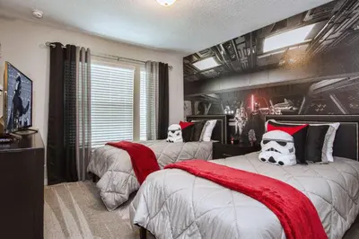 a bedroom with two beds with santa hats on them at Beautiful 4BD home Themed Pool and Grill 4417 in Kissimmee