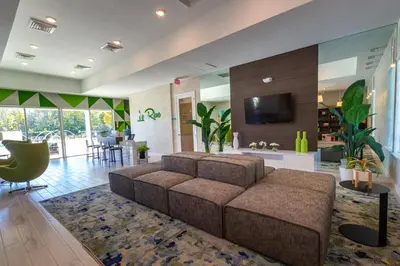 a large living room with a couch and a tv at Beautiful 4BD home Themed Pool and Grill 4417 in Kissimmee