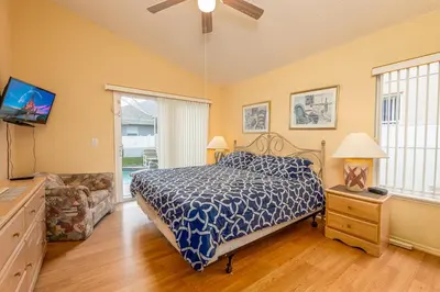 a bedroom with a bed and a tv and a couch at MVP 1511ABIB LONG TERM in Kissimmee