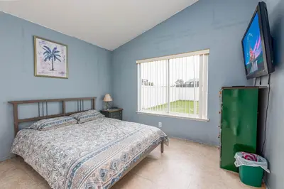 a bedroom with a bed and a flat screen tv at MVP 1511ABIB LONG TERM in Kissimmee