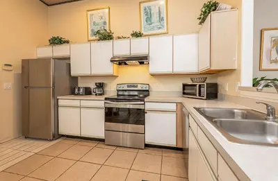 a kitchen with white cabinets and stainless steel appliances at MVP 1511ABIB LONG TERM in Kissimmee